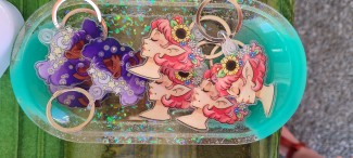 Profile view of a purple curly haired girl with stars in her hair.  Eyes are closed.  To the left.