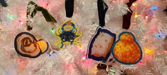 Colorful, flavorful acrylic ornaments on a white Christmas tree